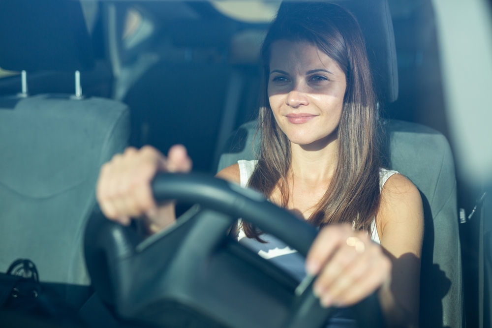 Positive,Young,Adult,Woman,Driving,Car,During,Solo,Trip,,Front