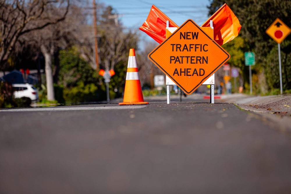 New,Traffic,Pattern,Ahead,Orange,Road,Sign,In,The,Middle